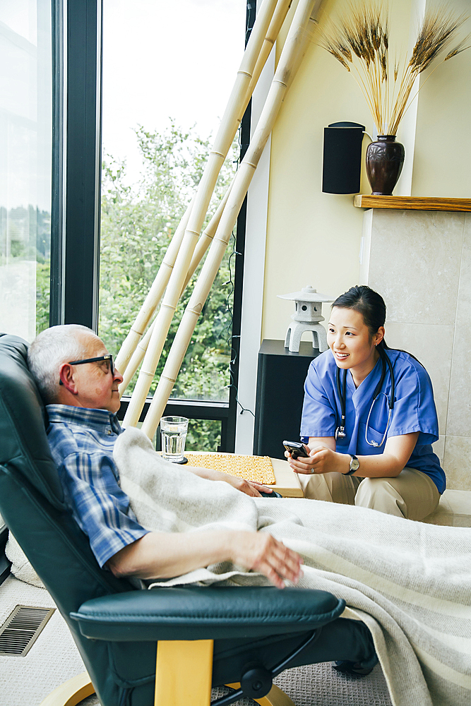 Nurse texting on cell phone near patient