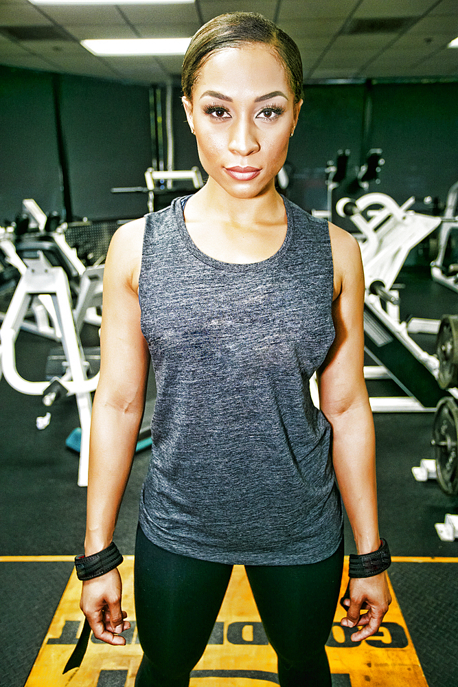 Serious Mixed Race woman posing in gymnasium