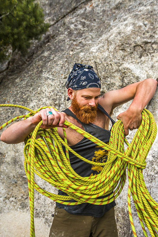 Caucasian man winding rope