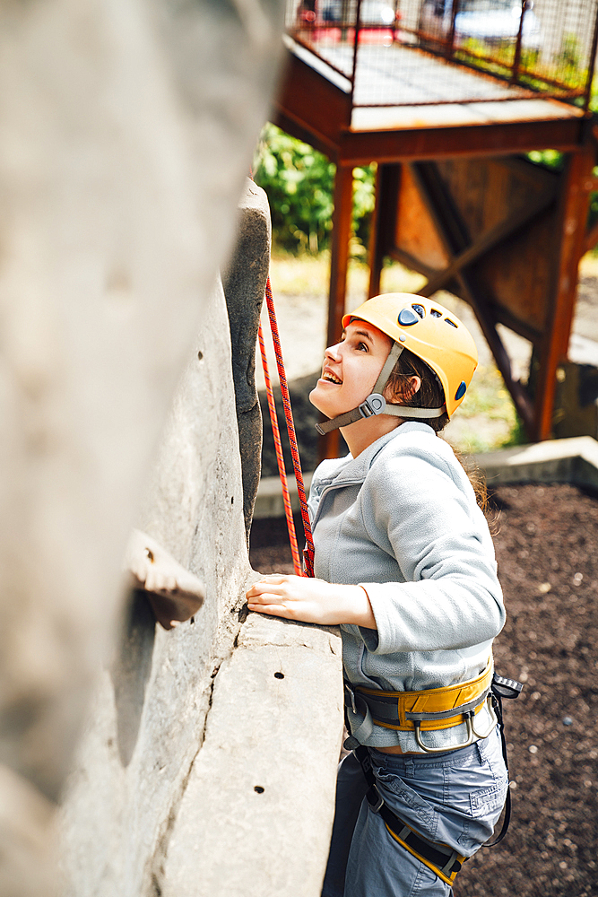 Caucasian woman climbing rock climbing wall