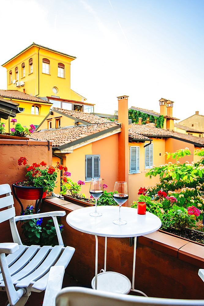 Wine glasses on balcony, Bologna, Emilia-Romagna, Italy