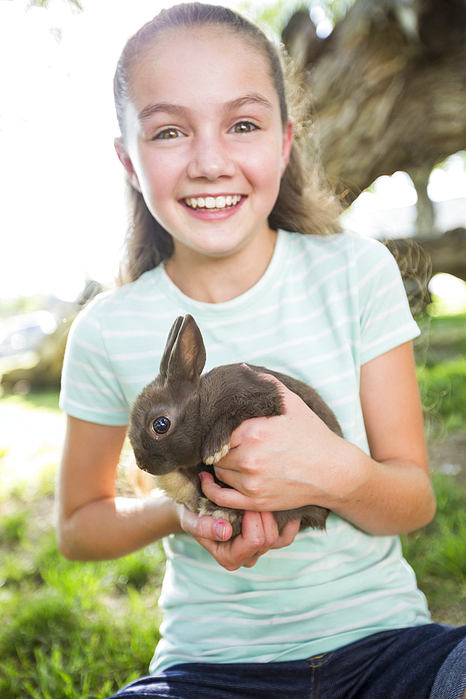 Caucasian girl holding rabbit