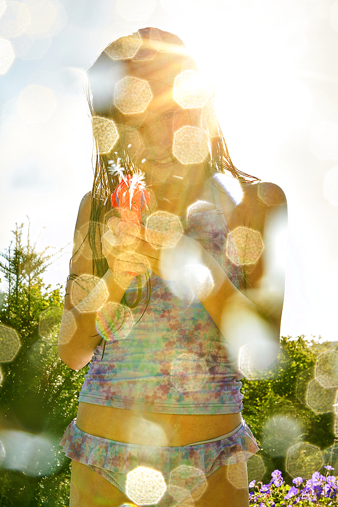 Portrait of Caucasian girl spraying water gun