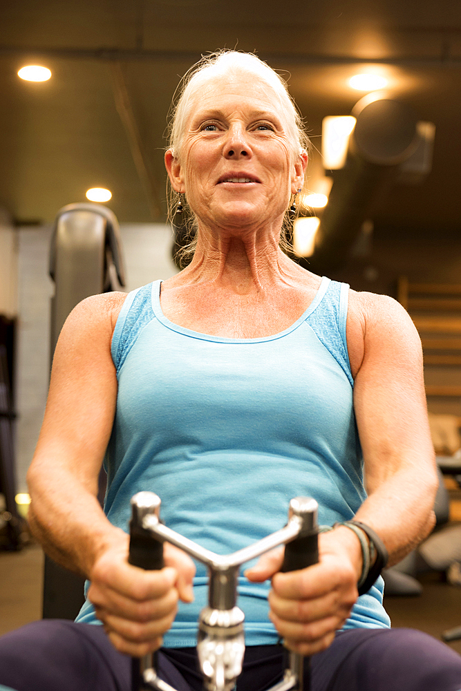 Smiling older woman working out in gymnasium