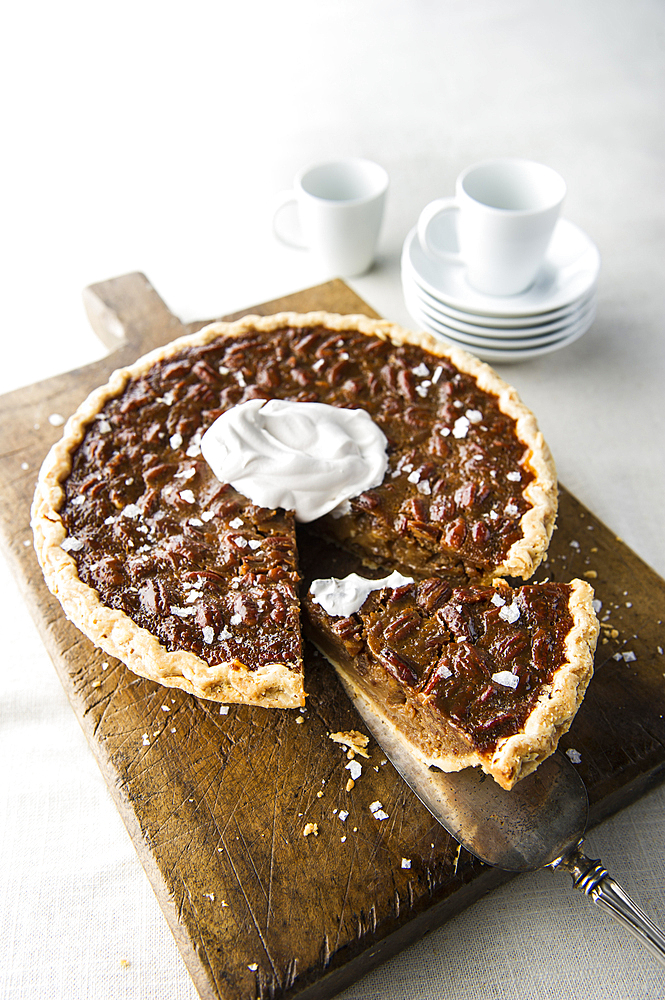 Caramel pecan pie on cutting board