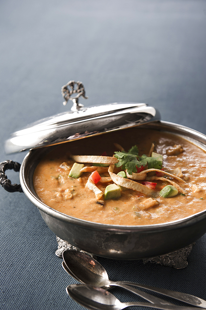 Tortilla soup in silver pot