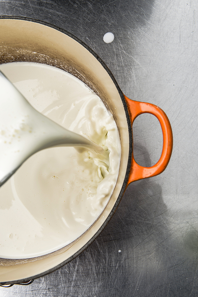 Milk pouring into pot