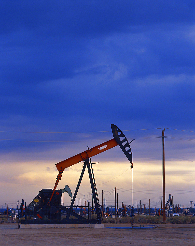 Oil rig drilling at sunset