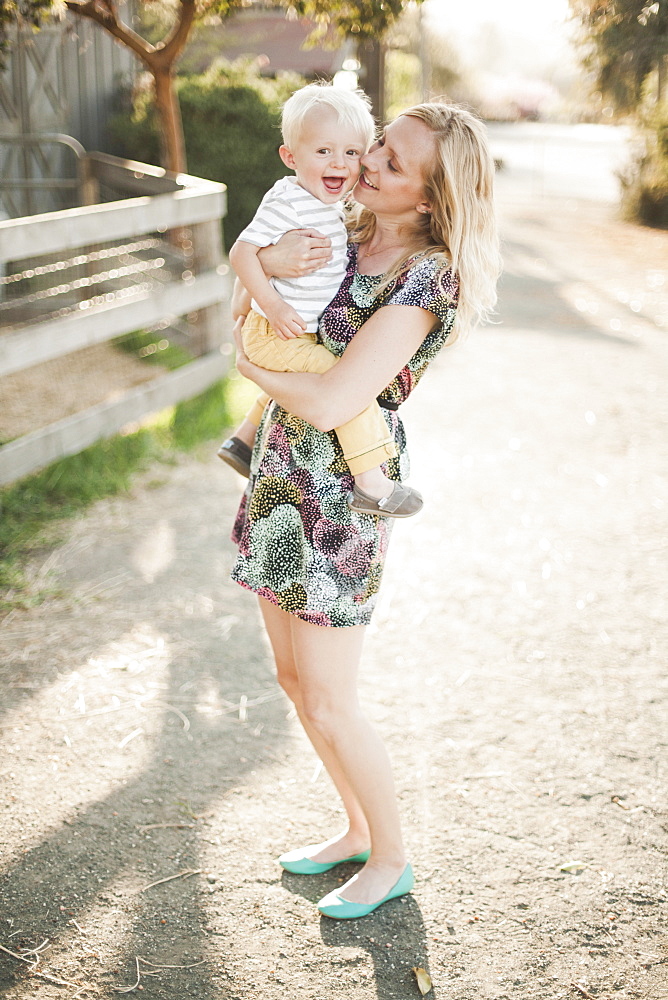 Mother holding son outdoors