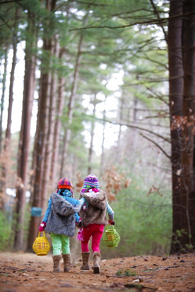 Caucasian girls walking in forest