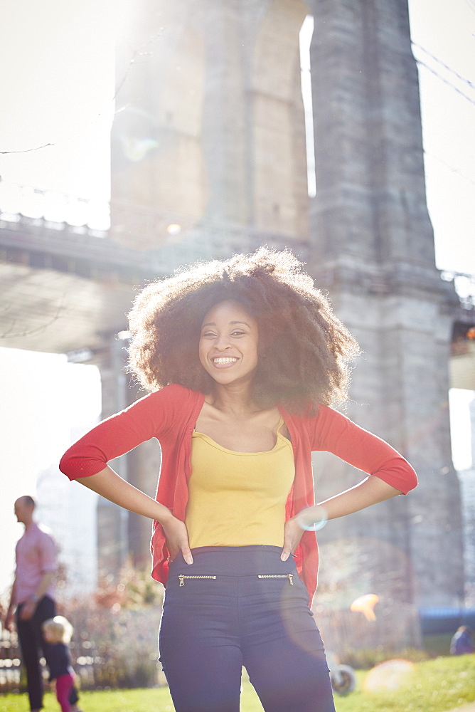 Smiling Black woman posing with hands on hips