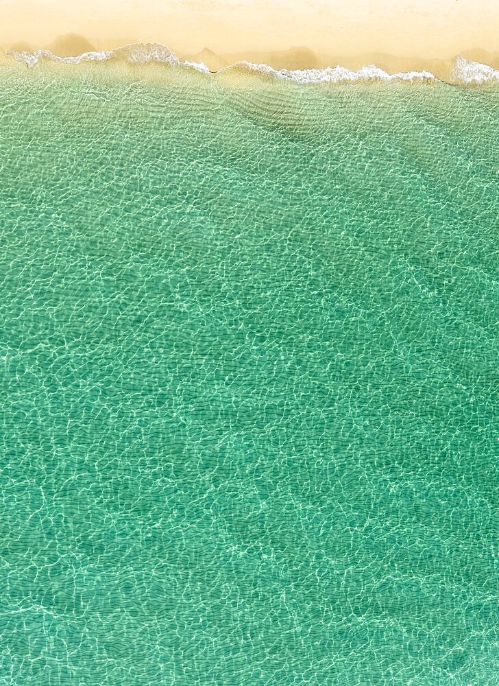 Overhead view of turquoise ocean and beach