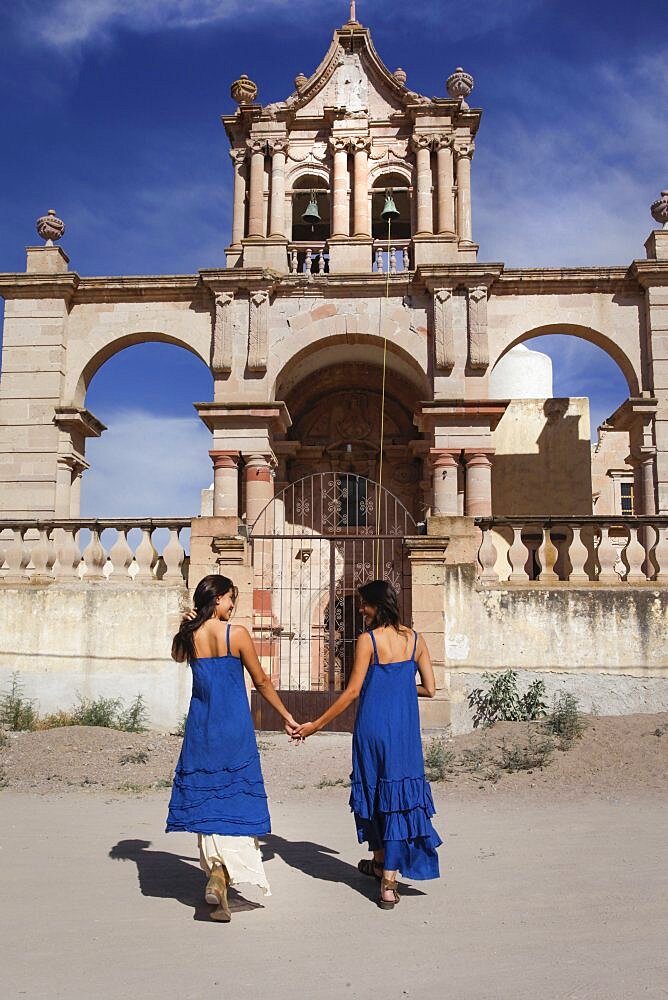 Mexico, San Felipe, Two women walking towards old church