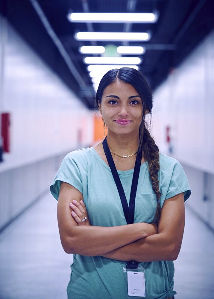 Portrait of smiling female technician in data center