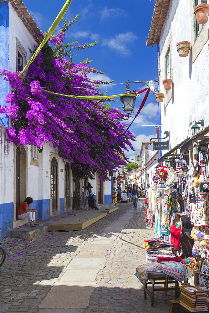 Tourists and shops in the typical alleys of the ancient fortified village of Obidos, Oeste Leiria District, Portugal, Europe