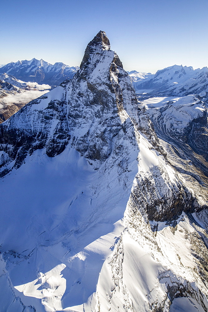 The unique shape of the Matterhorn sorrounded by its mountain range covered in snow, Swiss Canton of Valais, Swiss Alps, Switzerland, Europe