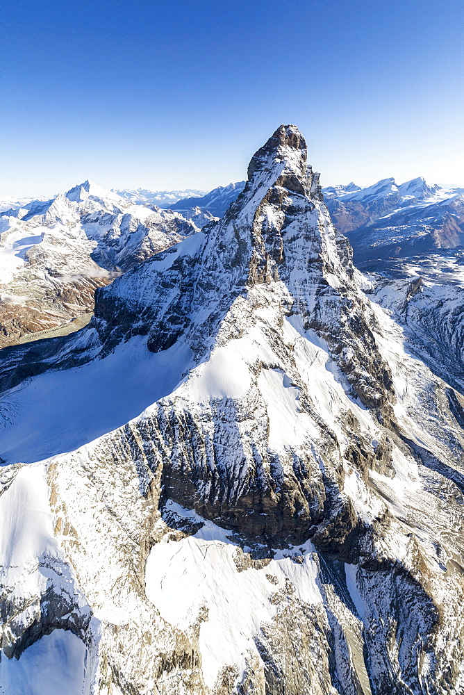 The unique shape of the Matterhorn sorrounded by its mountain range covered in snow, Swiss Canton of Valais, Swiss Alps, Switzerland, Europe