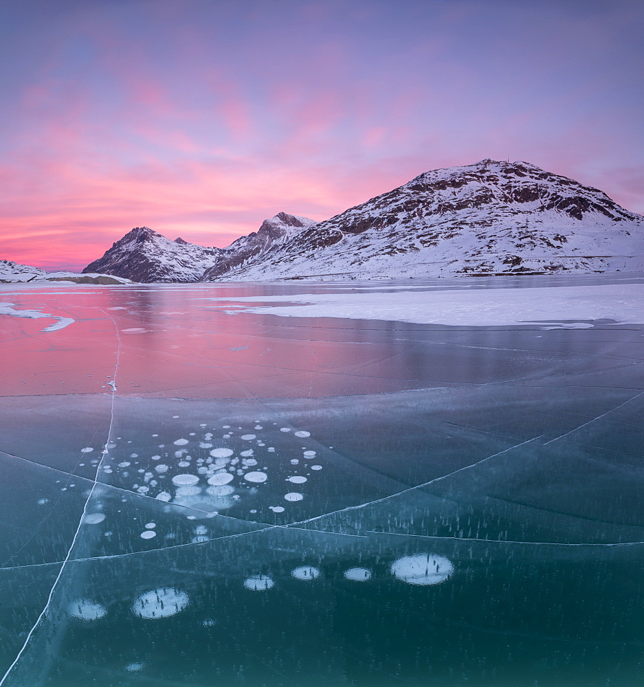 Panorama of ice bubbles and frozen surface of Lago Bianco at dawn, Bernina Pass, canton of Graubunden, Engadine, Switzerland, Europe