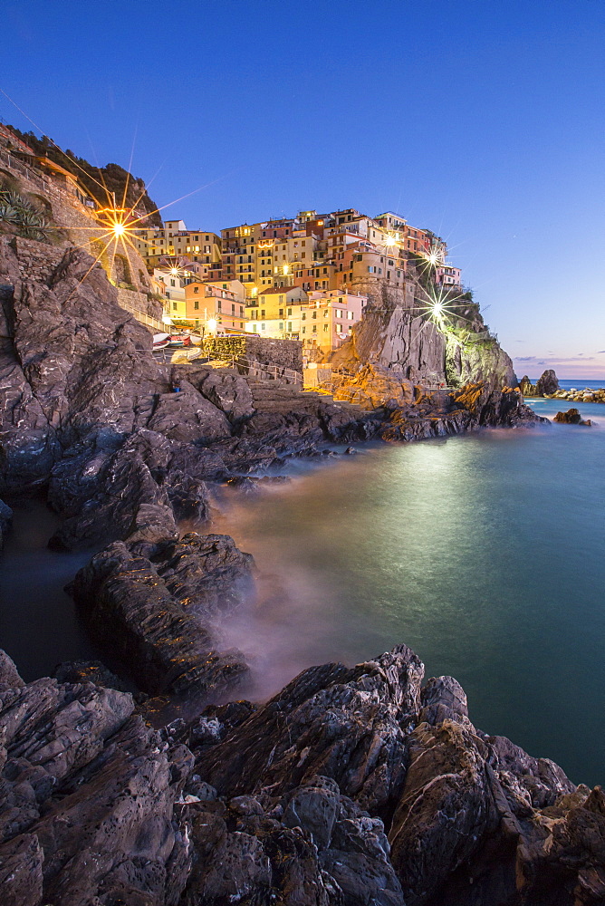 Blue hour in the little village of Manarola with its pastel coloured houses in the Cinque Terre National Park, UNESCO World Heritage Site, Liguria, Italy, Europe