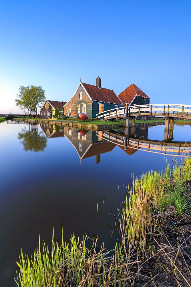 Blue dusk on wooden houses of the typical village of Zaanse Schans framed by River Zaan, Zaanse Schans, North Holland, The Netherlands, Europe