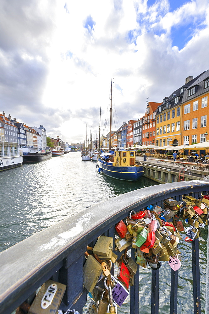 Padlocks on a terrace along the typical canal and harbour of the district of Nyhavn, Copenhagen, Denmark, Europe