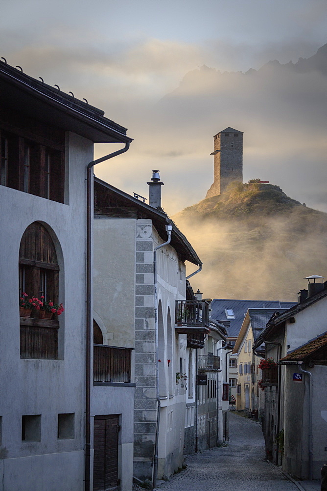 Misty sky on the alpine village of Ardez at sunrise, canton of Graub?nden, district of Inn, lower Engadine, Switzerland, Europe