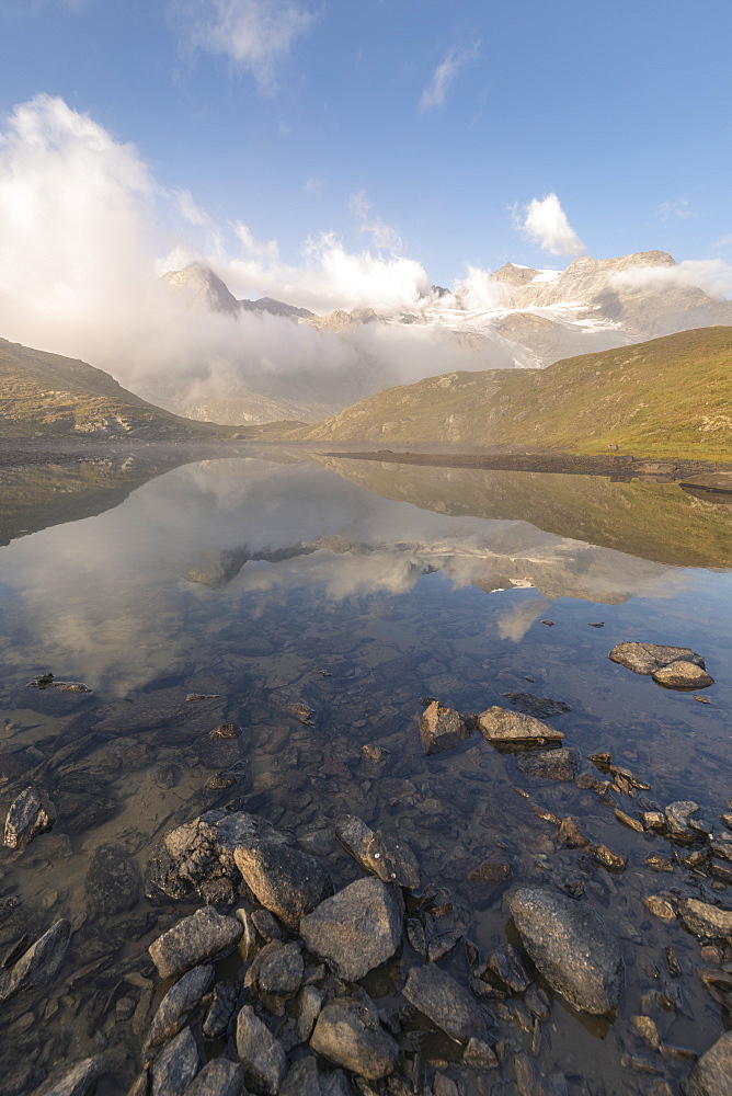 Peaks of mountain range reflected in alpine lake, Bernina Pass, Poschiavo Valley, Engadine, Canton of Graubunden, Switzerland, Europe