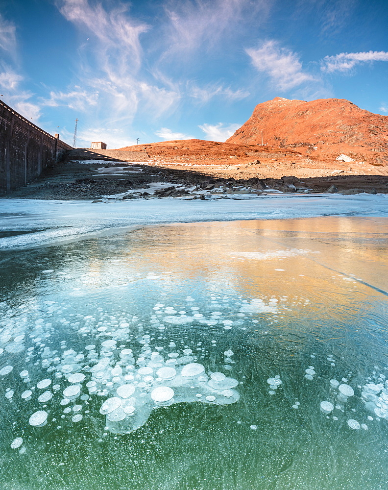 Panoramic of frozen lake Montespluga at dawn, Chiavenna Valley, Sondrio province, Valtellina, Lombardy, Italy, Europe