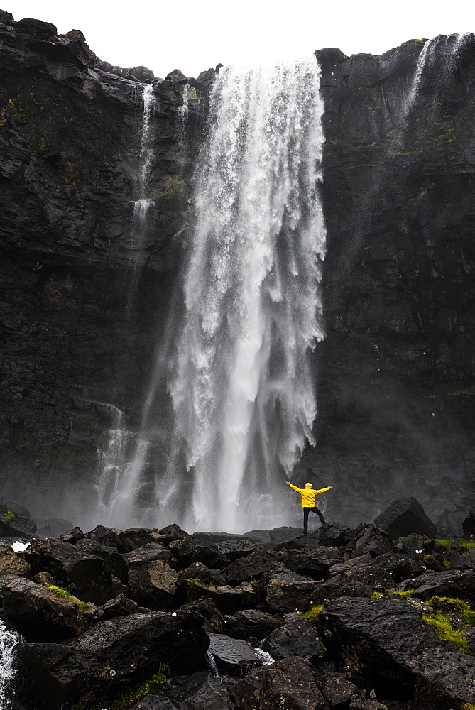 Hiker at Fossa waterfall, Streymoy island, Faroe Islands, Denmark, Europe