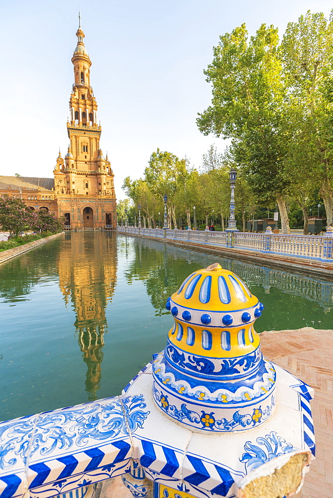 Old tower seen from the decorated ceramics balustrade along the canal, Plaza de Espana, Seville, Andalusia, Spain, Europe