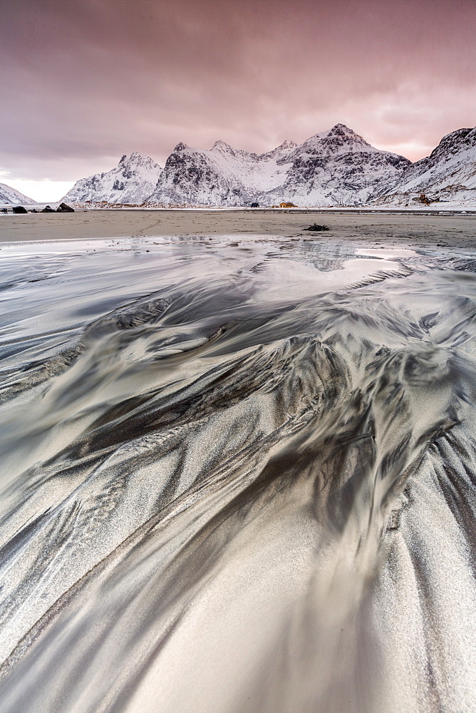 Sunset on the surreal Skagsanden beach surrounded by snow covered mountains, Flakstad, Lofoten Islands, Arctic, Norway, Scandinavia, Europe