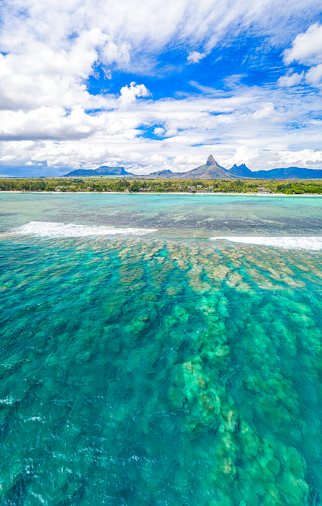 Aerial panoramic of coral reef and Piton de la Petite Riviere Noire mountain surrounding Flic en Flac beach, Black River, Mauritius, Indian Ocean, Africa