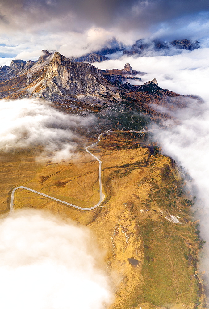 Aerial view by drone of Giau Pass, Ra Gusela and Cinque Torri in the mist of autumn, Dolomites, Belluno province, Veneto, Italy, Europe