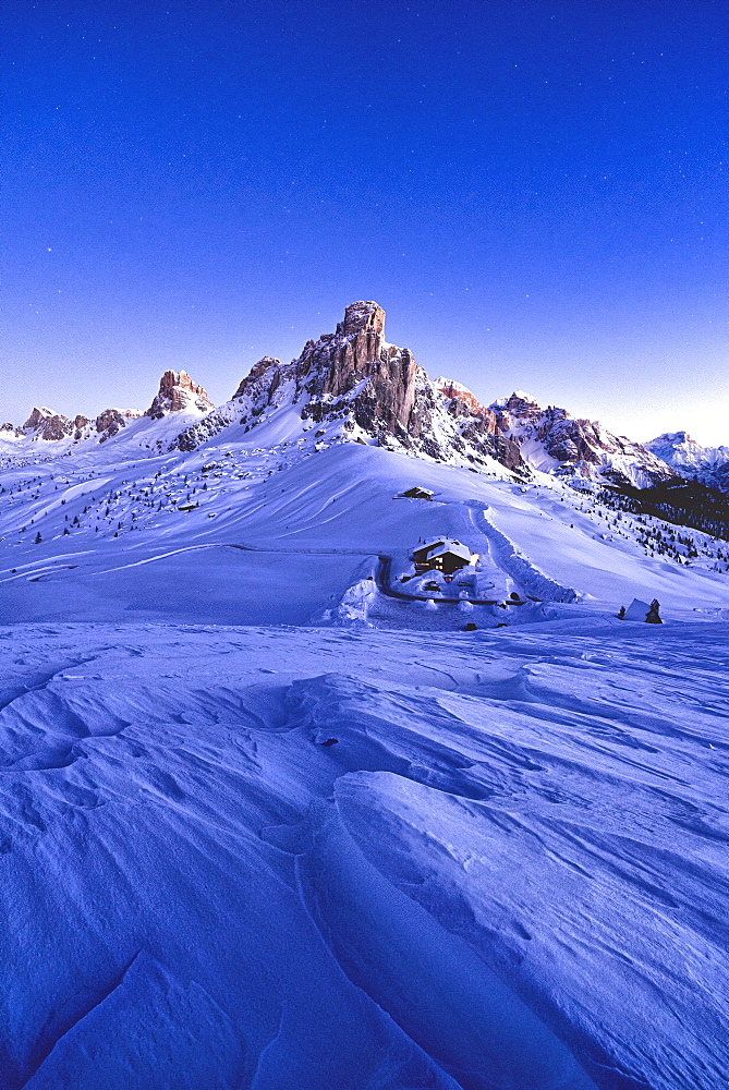 Starry sky at dusk on Ra Gusela mountain surrounded by fresh snow, Giau Pass, Dolomites, Belluno province, Veneto, Italy, Europe