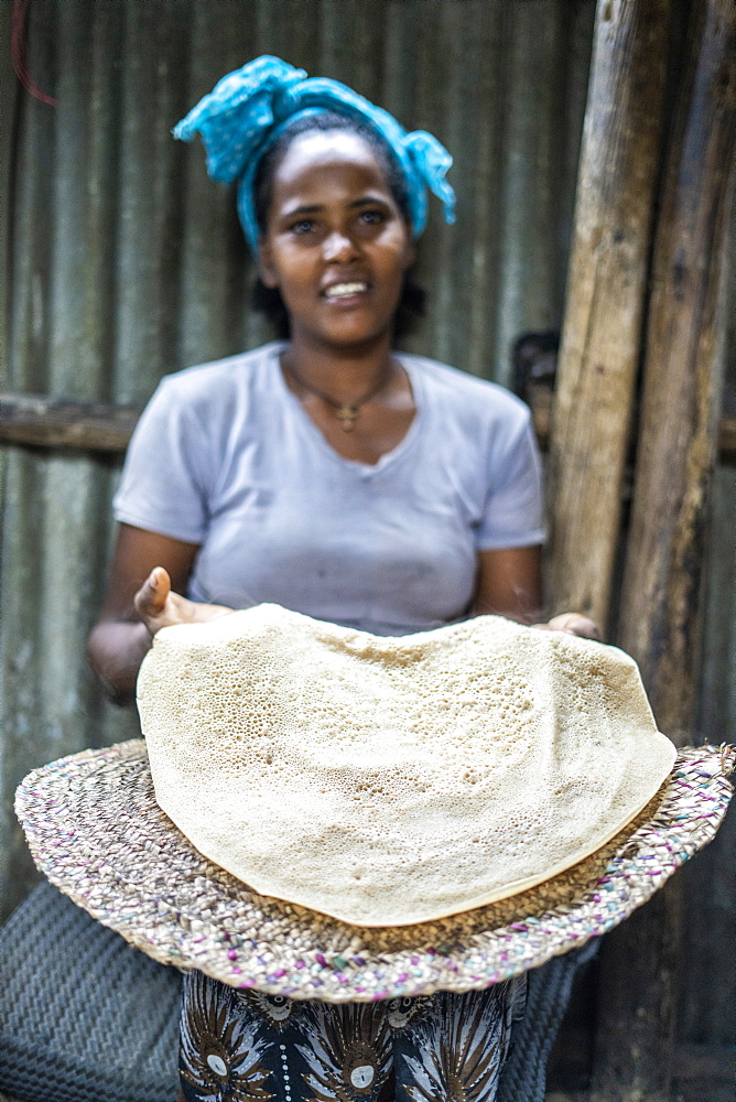 Woman showing the traditional Injera flatbread, Berhale, Afar Region, Ethiopia, Africa