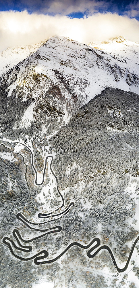 Bends of Maloja Pass road on snowy mountain ridge, aerial view, Bregaglia Valley, Engadine, canton of Graubunden, Switzerland, Europe