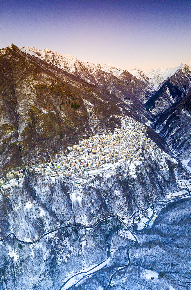 Aerial panoramic by drone of Premana village during winter dusk, Valsassina, Lecco province, Lombardy, Italy, Europe