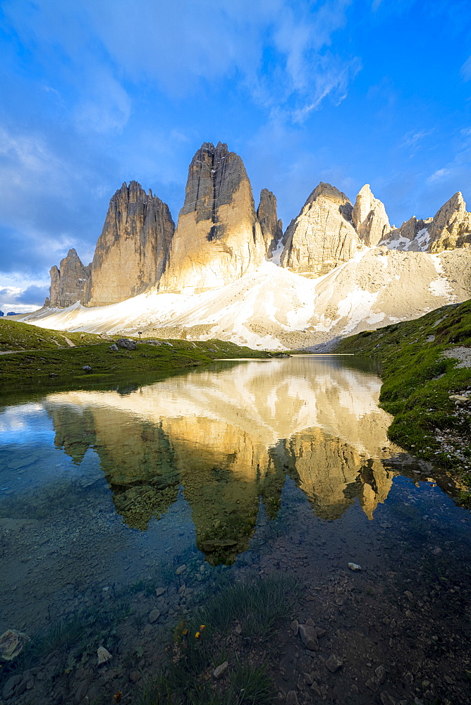 Sunset over Tre Cime di Lavaredo mirrored in Grava Longa lakes, Sesto Dolomites Natural Park, South Tyrol, Italy, Europe