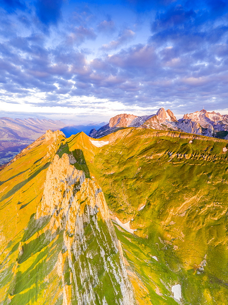 Clouds at dawn over the majestic peaks of Santis and Saxer Lucke, aerial view, Appenzell Canton, Alpstein Range, Switzerland, Europe