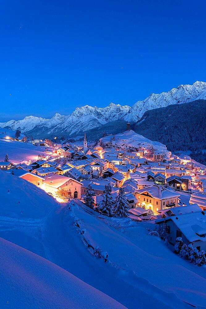 Traditional alpine village of Ardez covered with snow at dusk, Engadine, Graubunden Canton, Switzerland, Europe