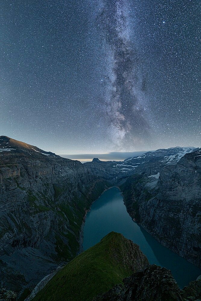 Milky Way in the starry night sky over lake Limmernsee, aerial view, Canton of Glarus, Switzerland, Europe