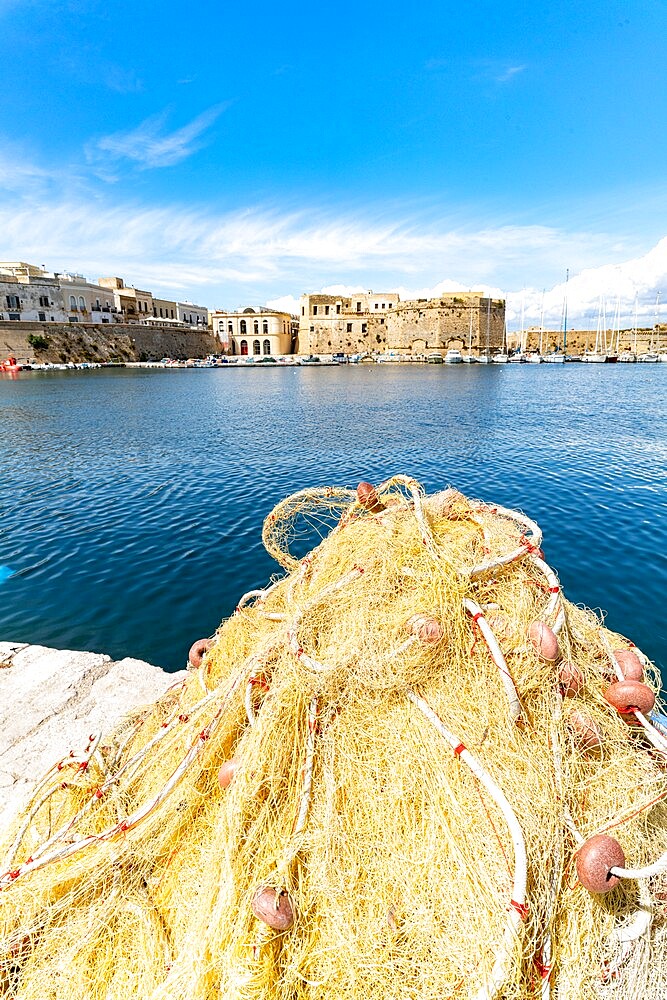 Fishing nets in the harbor surrounded by old town and castle by the sea, Gallipoli, Lecce province, Salento, Apulia, Italy, Europe