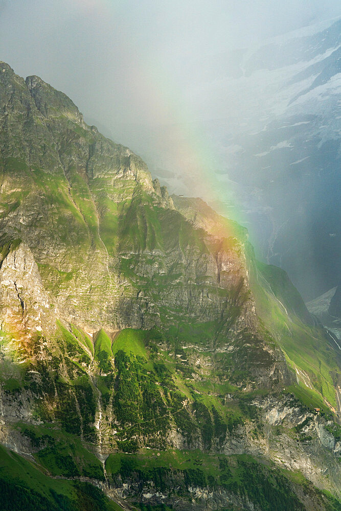 Rainbow over the majestic Wetterhorn mountain in summer, aerial view, Grindelwald, Bernese Alps, Canton of Bern, Switzerland, Europe