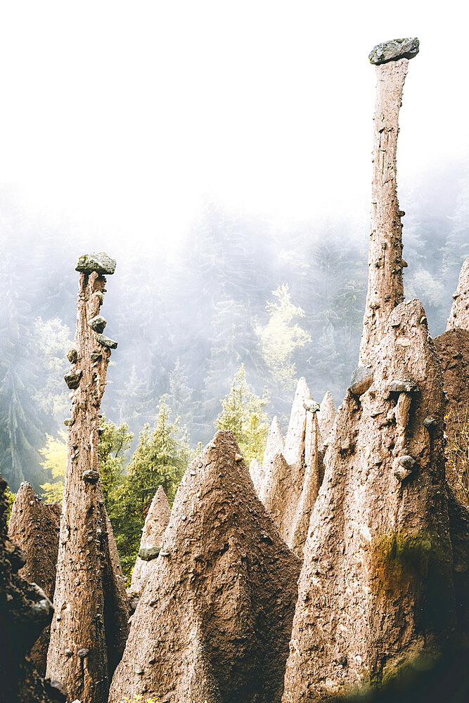 Foggy sky over the earth pyramids, ancient rock formation, Renon (Ritten), Bolzano, South Tyrol, Italy, Europe