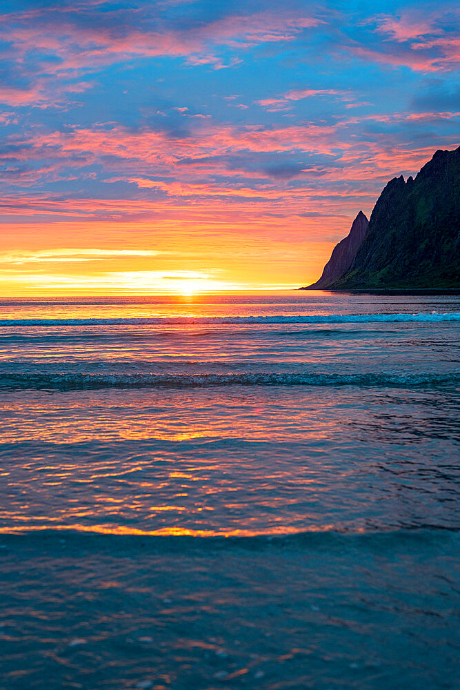 Burning sky of midnight sun reflecting in the sea, Ersfjord, Senja, Troms county, Norway, Scandinavia, Europe