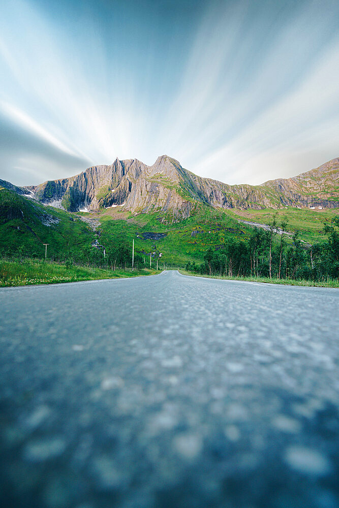 Long exposure of clouds over mountains view from the empty road, Senja, Troms county, Norway, Scandinavia, Europe