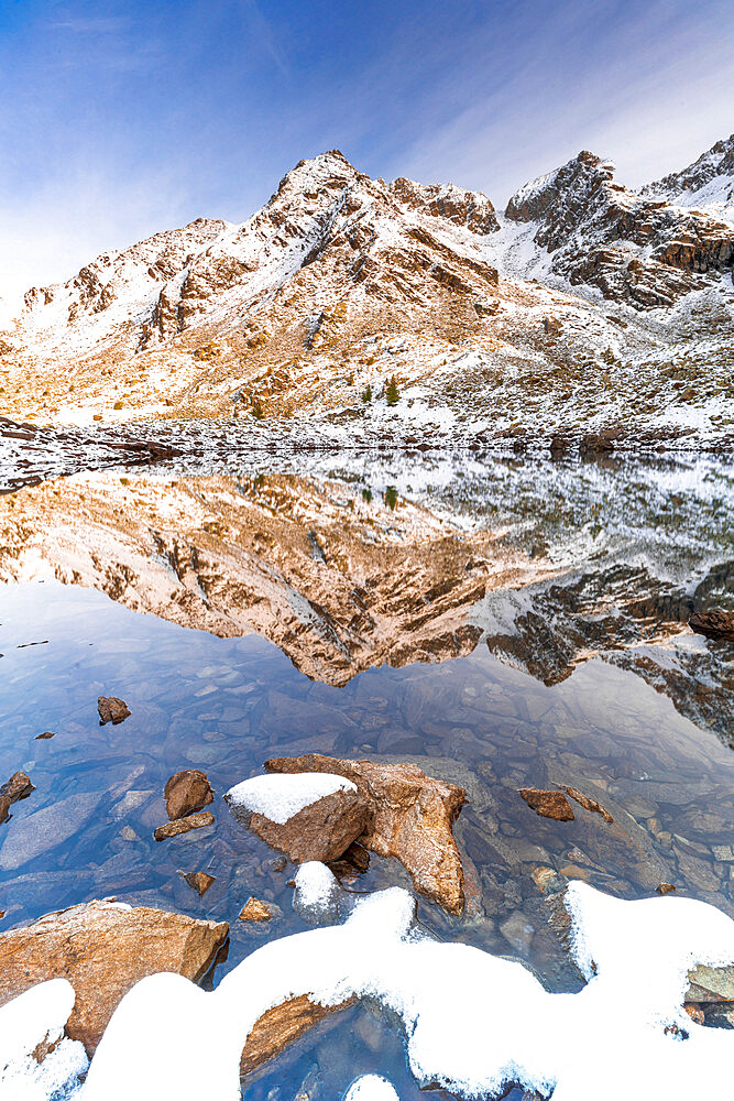 Corna Nera mountain peak reflected in Rogneda lake during the autumn sunrise, Rhaetian Alps, Sondrio, Lombardy, Italy, Europe