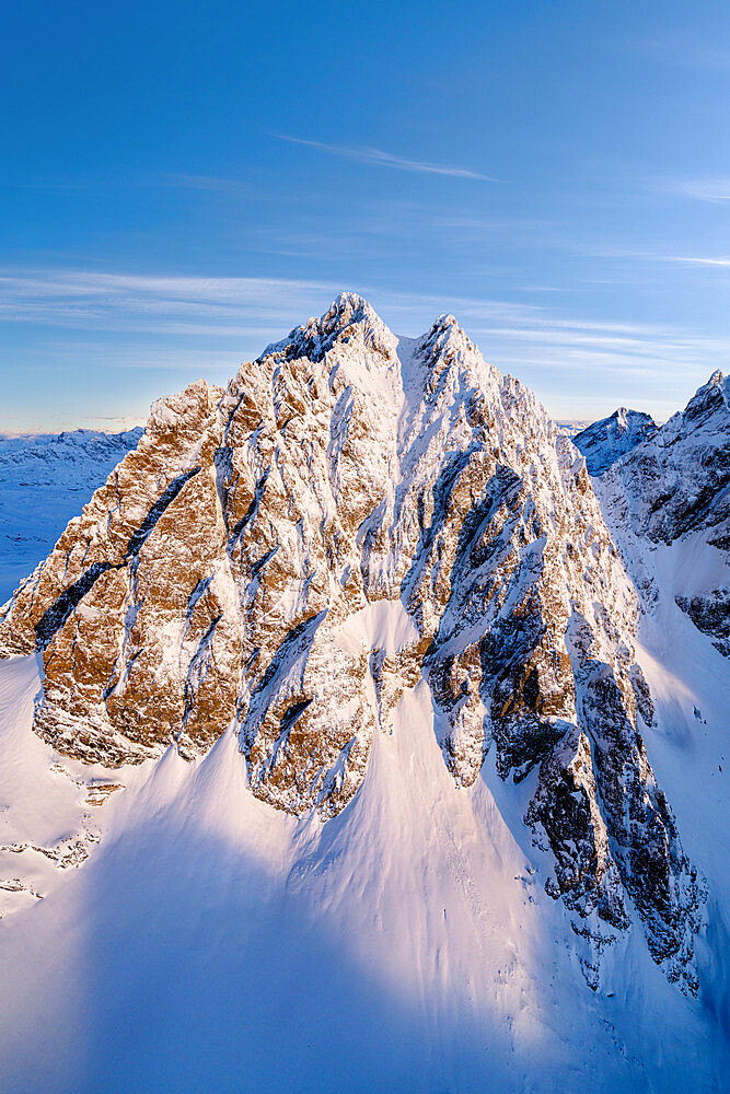 Winter sunrise over the snowcapped Piz Roseg peak, aerial view, Valmalenco, Valtellina, Lombardy, Italy, Europe