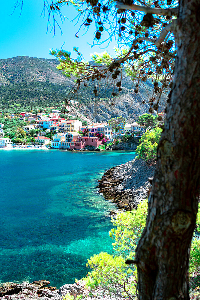 Multicolored buildings of the small Assos town overlooking the turquoise sea, Assos, Kefalonia, Ionian Islands, Greek Islands, Greece, Europe