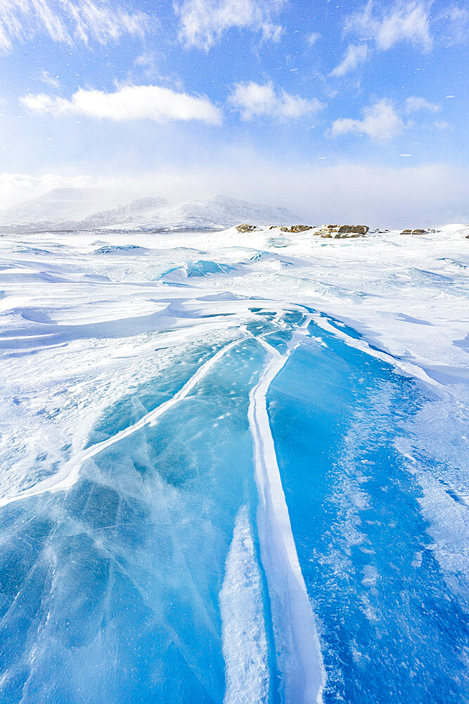 Rippled transparent ice covering a lake in the snowy landscape, Stora Sjofallet, Norrbotten County, Lapland, Sweden, Scandinavia, Europe